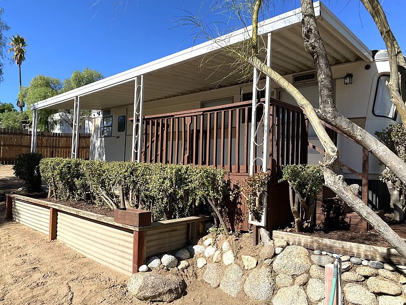 Front view of our 1956 Spartan Royal Mansion Vintage Trailer with front deck and planter.