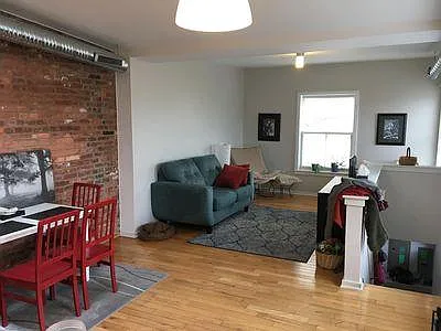 Previous tenant dining and living area with staircase on the right.