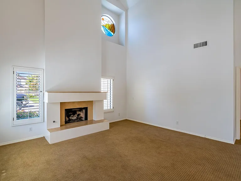 Spacious living room with gas fireplace and vaulted ceilings.