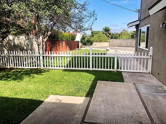 Large backyard with enclosed fence.