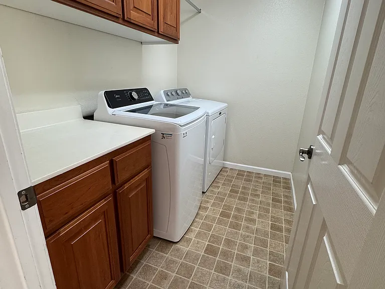 Laundry Room w/ Washer & Dryer, Storage Cabinets, Hanging Rack & Folding Counter