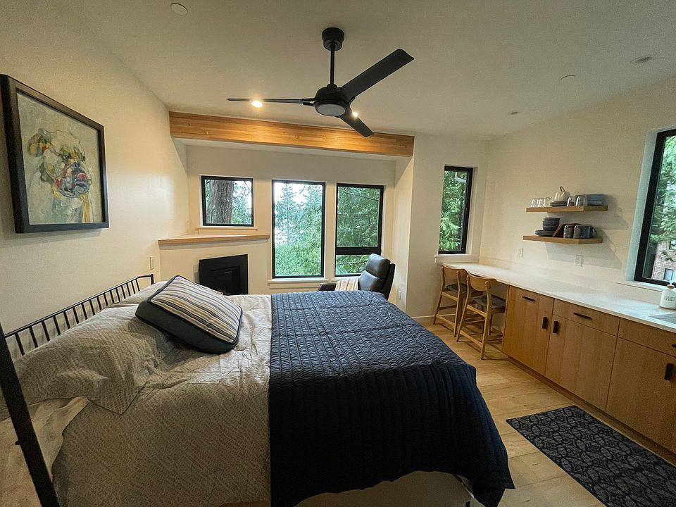 View to the west with propane fireplace in corner and eating space at end of counter.