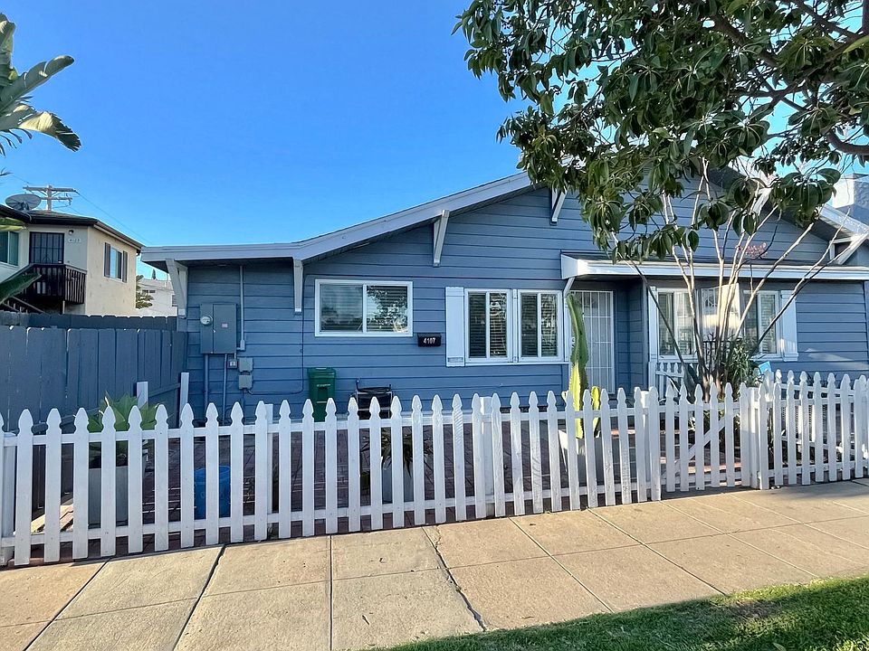 This is the view of the House from the street. Access to the House front door is either through the white picket fence. Additonal access could be through the side wooden gate (on the left of the house) that opens up to the back yard of the house.