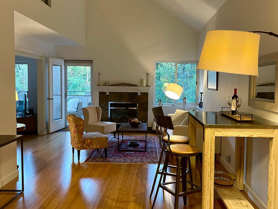 dining room and living room with fire place and door connecting to terrace