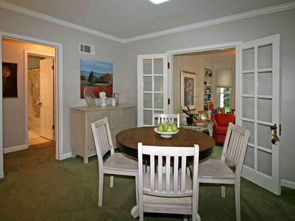 Right off the kitchen is a good sized eating area large enough to seat most families.  French doors open up to a sun lit den.  All the walls are painted a beautiful neutral color that accentuate the crown molding and will go with most furniture.