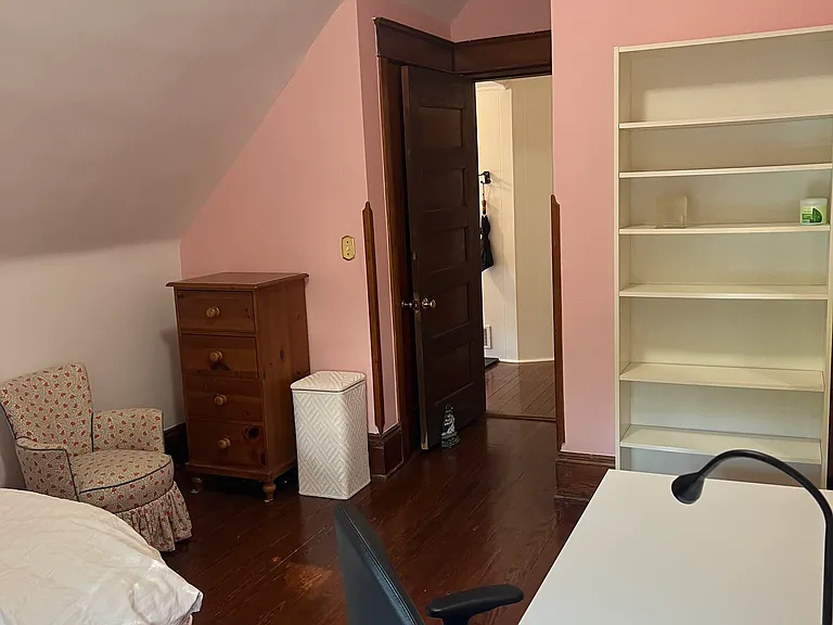 Office desk, lamp, easy desk chair with swivel, and bookcase. Comfy chair, dresser and laundry basket in background. All pine floors and furniture...