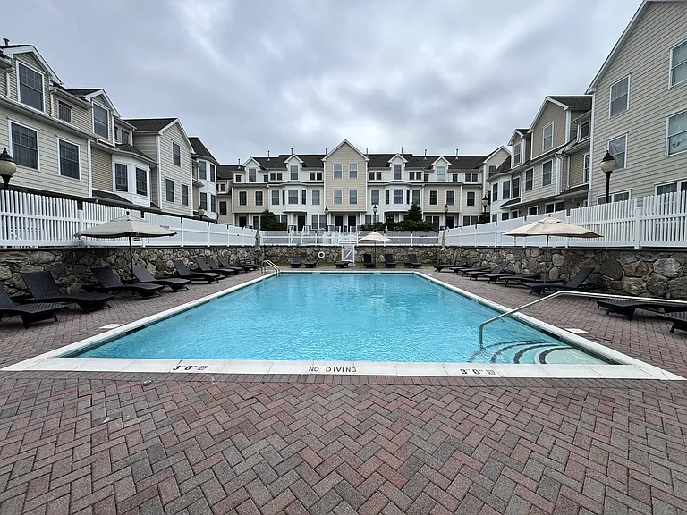 Spacious pool with small lawn area in the back.