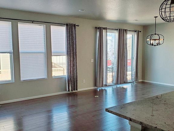 Family room & dining area with hardwood floor, recessed LED lights and lamps