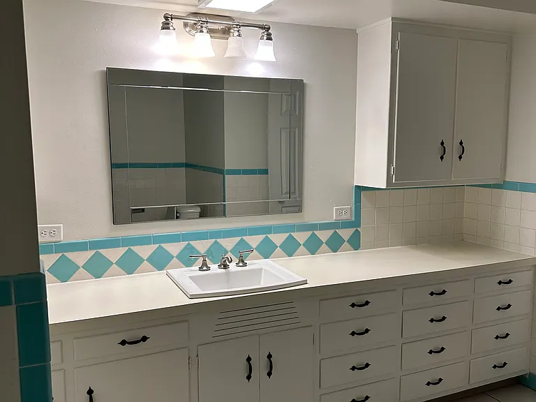 Main bathroom features a shower/tub combination and ample storage.