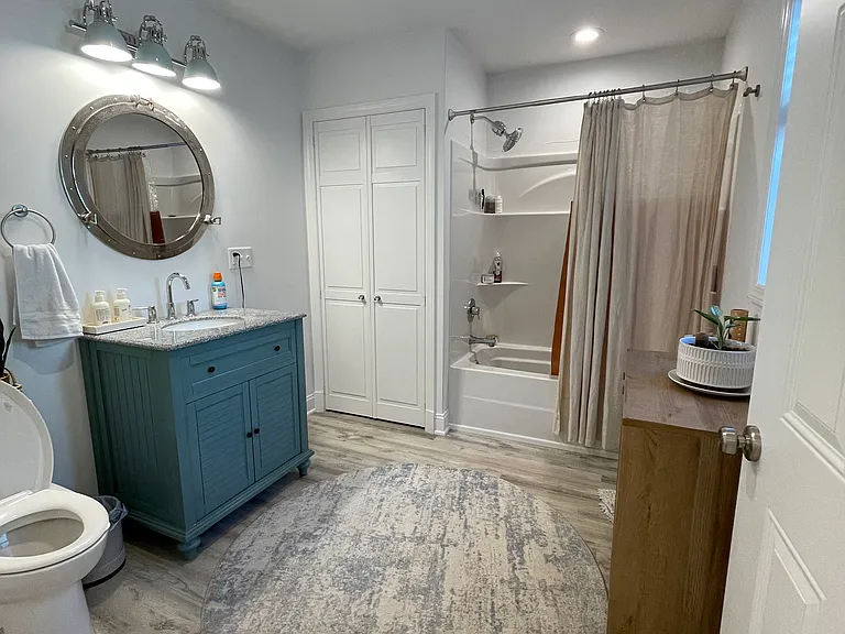 Oversized first-floor bathroom with tub/shower combo and closet for washer and dryer