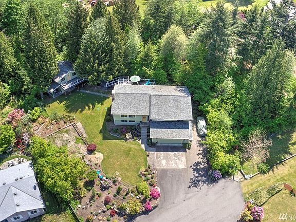 You'll be delighted by this .82 acre parcel. The home is backed by a lush greenbelt and is landscaped with gorgeous perennials. This is truly a one of a kind home where you'll feel a million miles away yet still enjoy convenient access to freeways, SeaTac airport, hospital, major retail, dining and business hubs. 