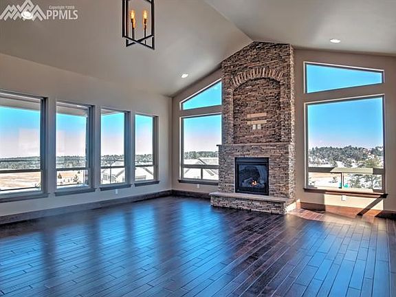 Great room with vaulted ceilings and one of three gas fireplaces. Ask agent about plans for ceiling beams.