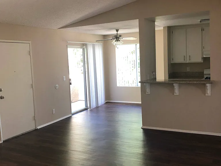 View of dining room , private poarch and kitchen from living room at Grande Vista Apartments.