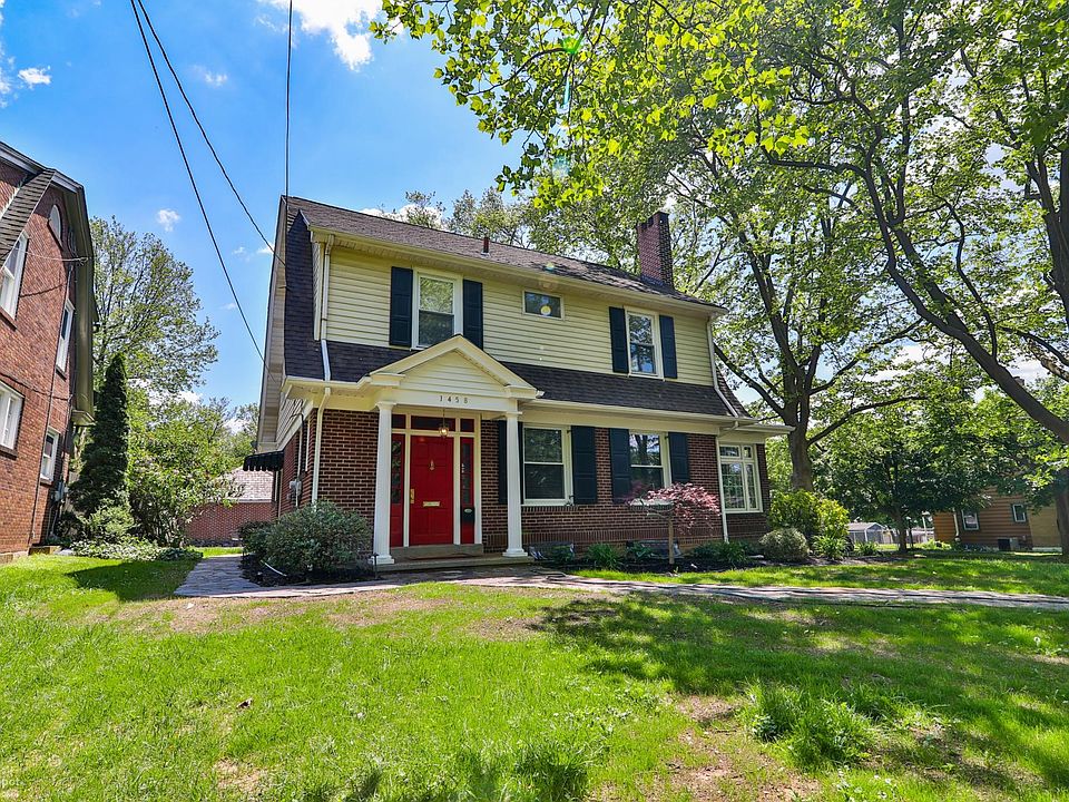 Front of home with new landscaping and in ground lighting.