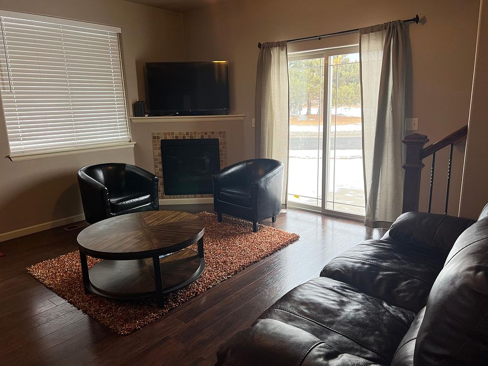 Living room w/gas fire place & access to side patio