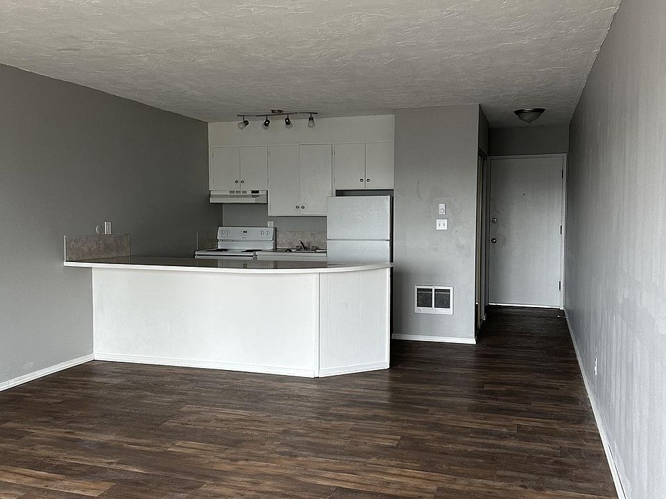 View of living room, kitchen and hallway from near the sliding glass door