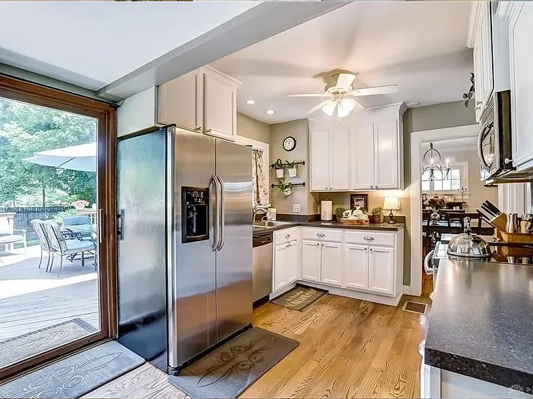 Kitchen to northeast with French door refrigerator and sliding glass doors opening onto the deck.