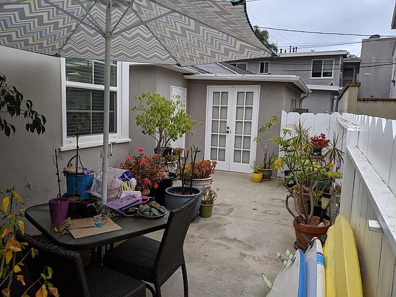 Double wooden doors lead to storage room, children's play room, or office. Room has electricity. Garage is the door to the left in this photo.
