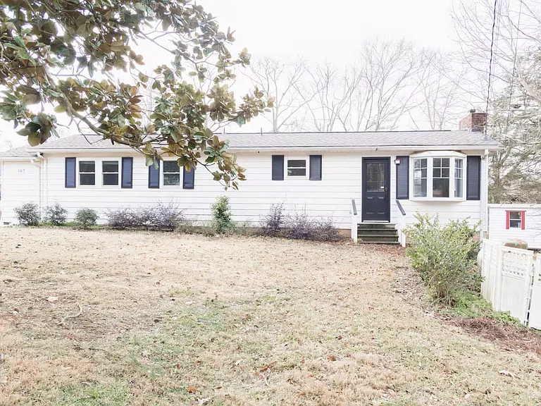 Front of property, includes long driveway.