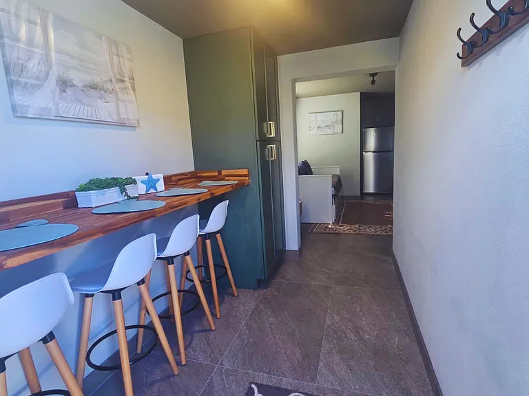 Charming dining area with beautiful accents and convenient storage.