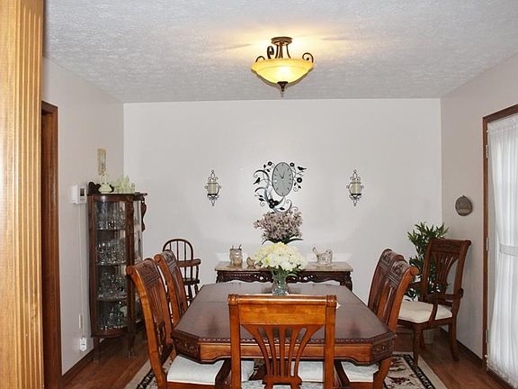 Formal dining room with opening to great room. Hardwood flooring