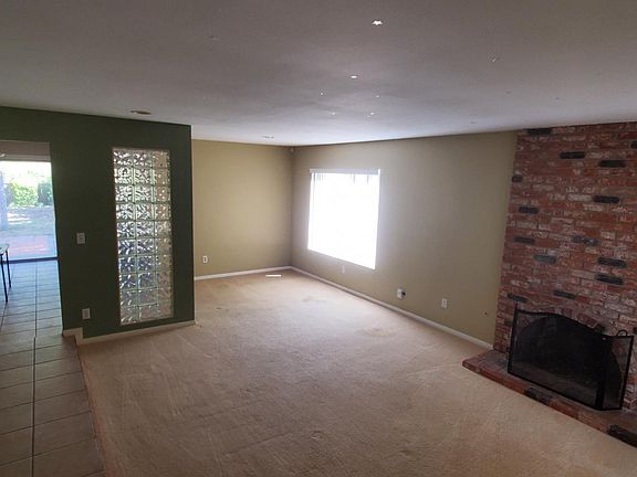 View of living room on right, looking through dining area into back yard. Taken with back to front door
