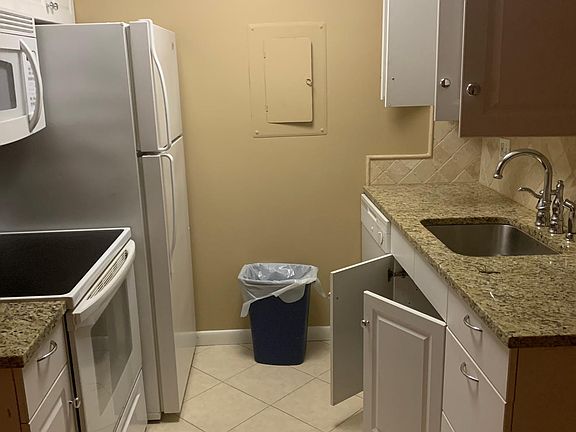 Kitchen with granite counters, dishwasher and built in microwave