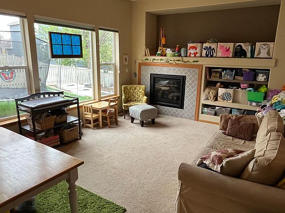 Family room with new fireplace. Garden plots visible through the window.