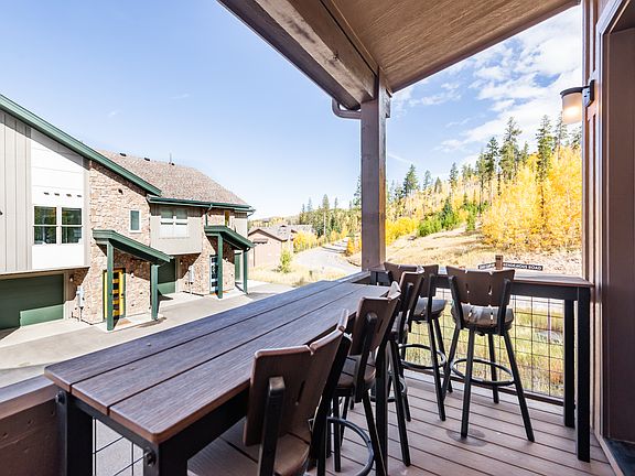Step onto the covered patio off the living room, featuring generous seating for effortless indoor-outdoor living!