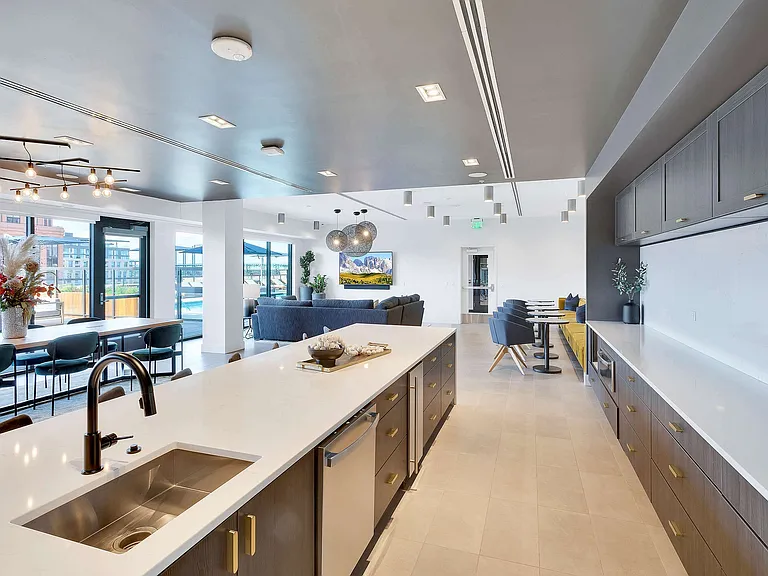 Luxurious modern apartment interior with a sleek open-concept kitchen, stylish living area, and large windows offering stunning views.
