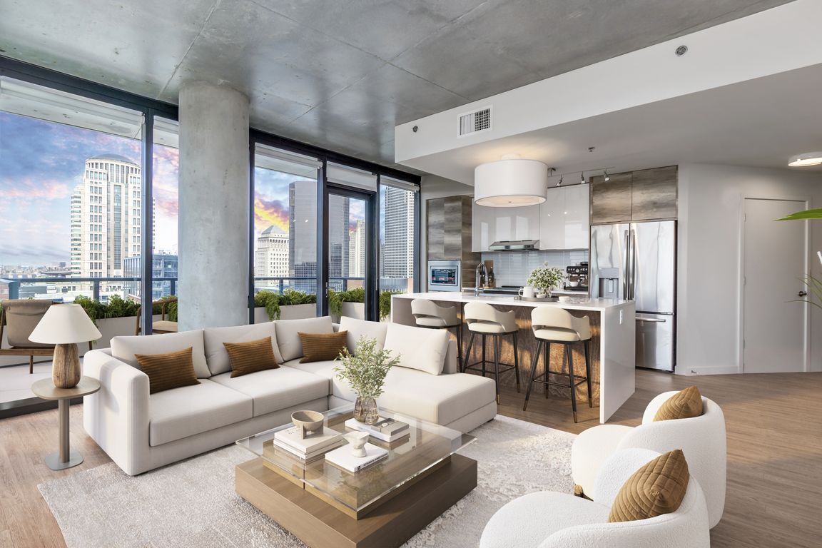 Open-concept living with floor to ceiling windows at One Cardinal Way