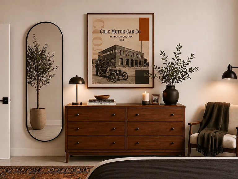 Modern bedroom with wood dresser and artwork at Cole Motor Apartments, Indiana