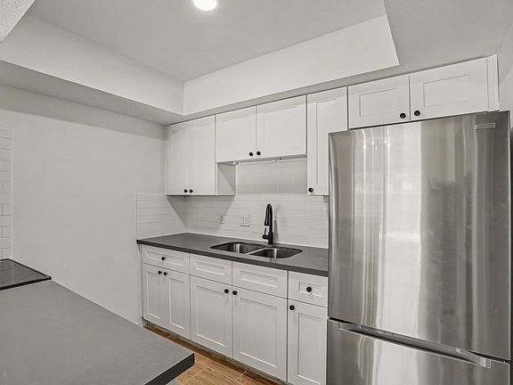 Kitchen. New stainless steel appliances. Fridge w/ bottom drawer freezer + range /oven.