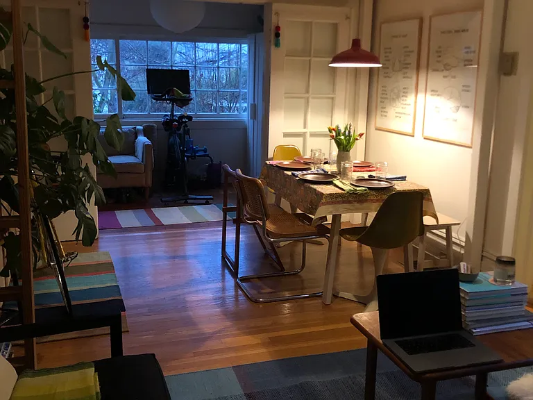 Evening photo from living room looking toward sunroom with loft overhead