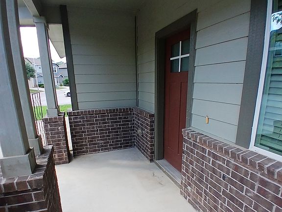 Entry door welcomes you to a charming front porch