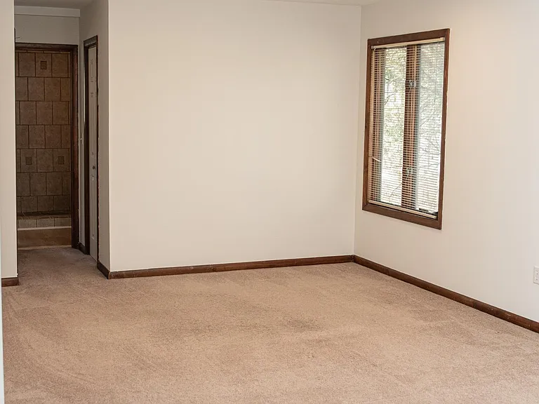Another view of the primary bedroom with connecting bathroom