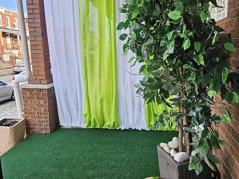 Front porch added curtains for privacy on both sides.