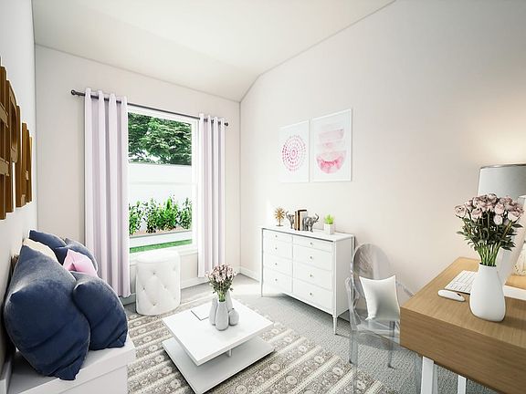 A cozy and bright living room with a white dresser, a coffee table, and a large window overlooking a