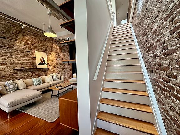Steps across from front door lead up to second floor kitchen/sitting area, dining and additional bedroom and bathroom, another flight of stairs that take you to the roof.