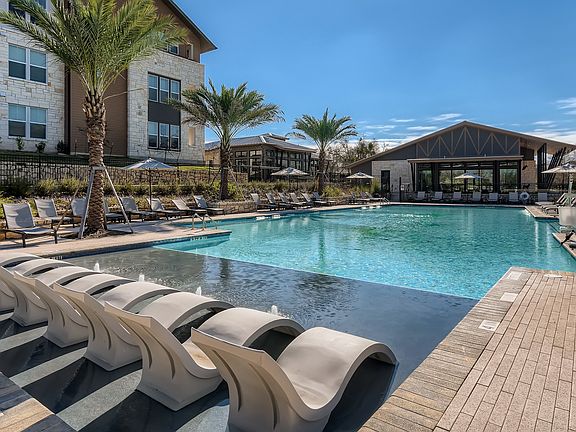 Resort-style swimming pool with in-water lounge chairs