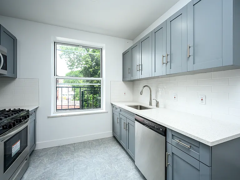 Kitchen featuring granite countertops, dishwasher, microwave oven, and stove.