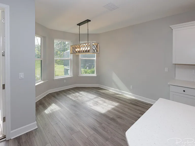 Dining nook with upgraded lighting and bay window