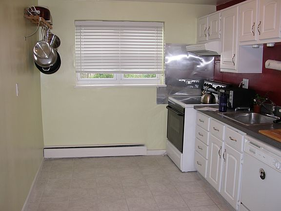 Newly updated kitchen with ceramic tiles, paint, appliances, and cabinets