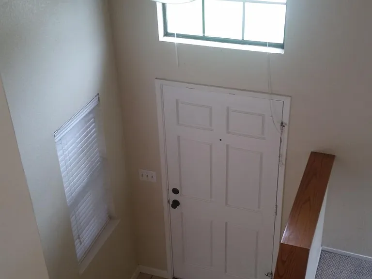 Tile entry way, laminate flooring throughout first level. Carpeted stairway and two carpeted bedrooms upstairs. Half bathroom downstairs and full bathroom upstairs.