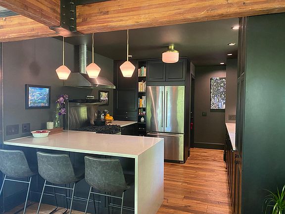 Breakfast bar with waterfall counters, all new floor to ceiling cabinetry.