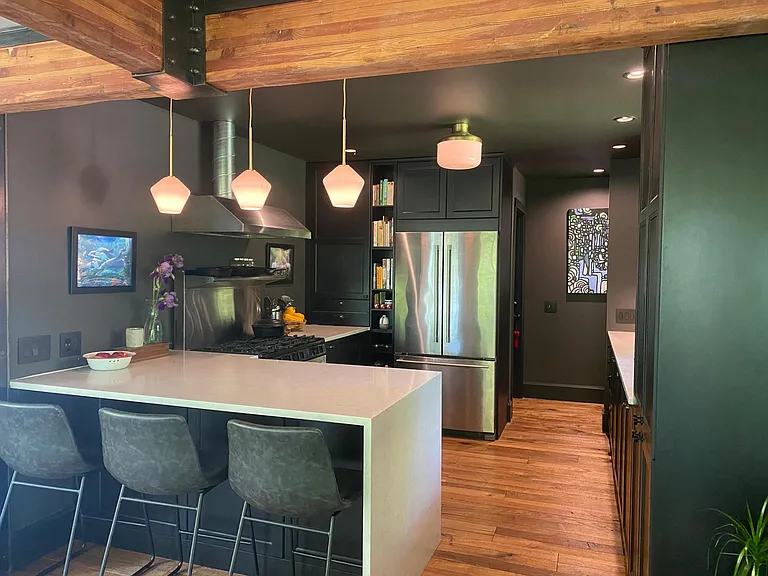 Breakfast bar with waterfall counters, all new floor to ceiling cabinetry.
