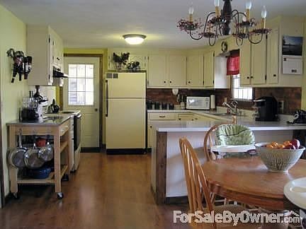 Kitchen
						:
						Eat-in Kitchen plus bar area. Newer wood laminate flooring.