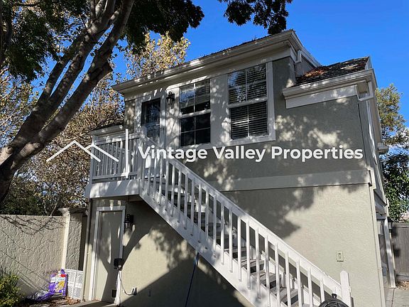 Studio entrance with side garage door below leading to on-site laundry (not shared)