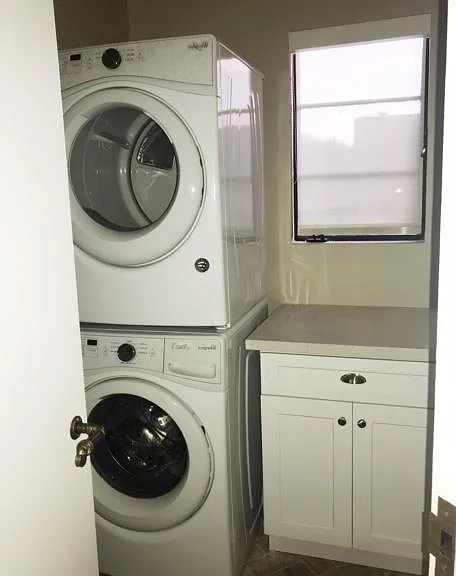 Laundry room with storage and counter space. Washer and dryer included.