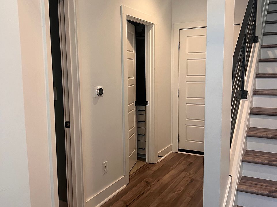 1st floor entryway looking at full bathroom and first floor bedroom/office